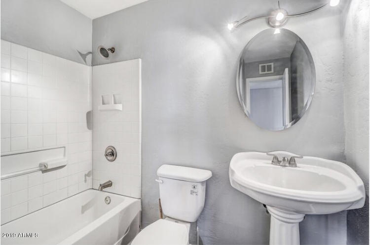 3249 West Citrus Way Phoenix, AZ 85017 - Photo 13 of 22 a bathroom with a sink toilet and shower