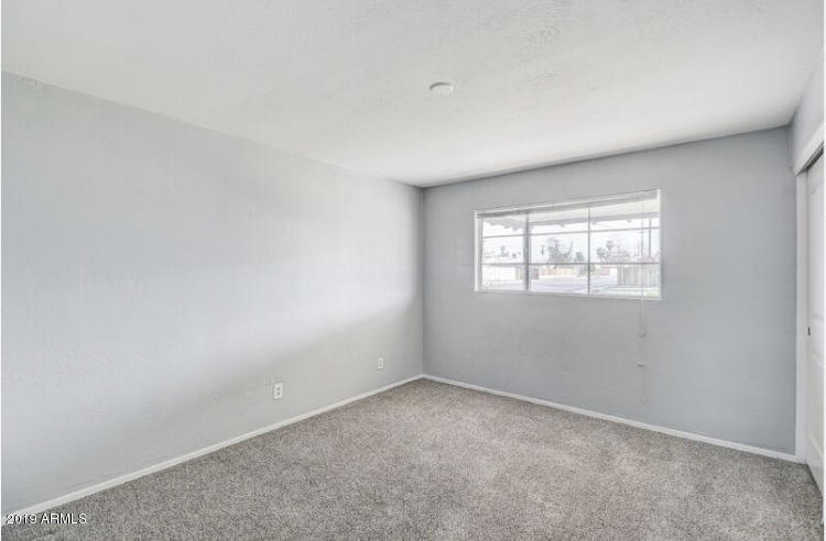3249 West Citrus Way Phoenix, AZ 85017 - Photo 14 of 22 an empty room with a window