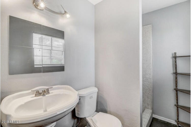 3249 West Citrus Way Phoenix, AZ 85017 - Photo 19 of 22 a bathroom with a sink mirror and toilet