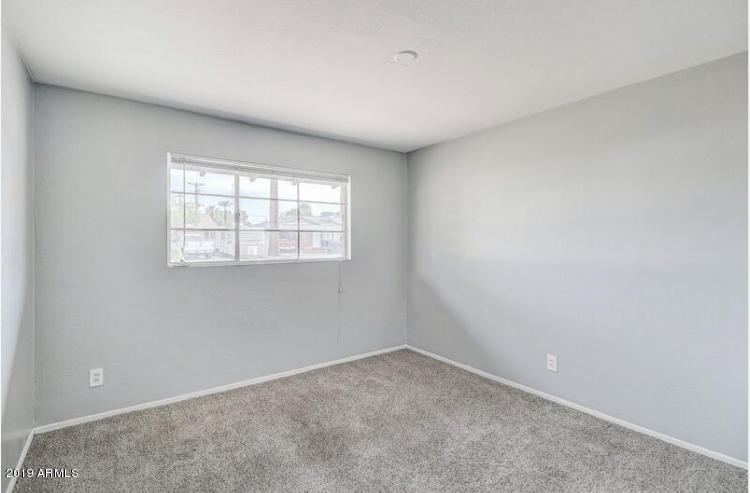 3249 West Citrus Way Phoenix, AZ 85017 - Photo 9 of 22 an empty room with a window