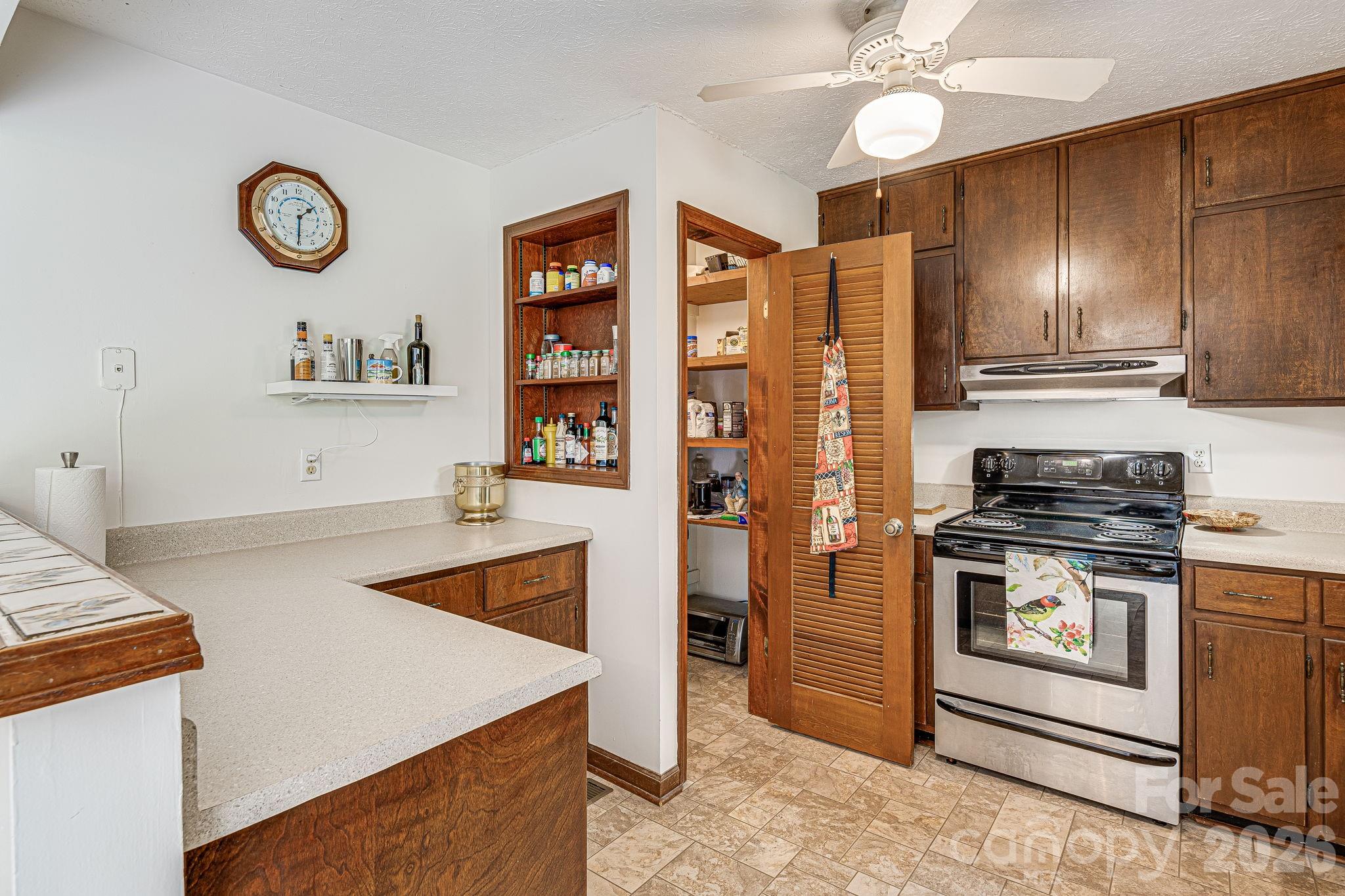 61 Spring Cove Drive Brevard, NC 28712 - Photo 11 of 39 a kitchen with stainless steel appliances granite countertop a stove and a refrigerator