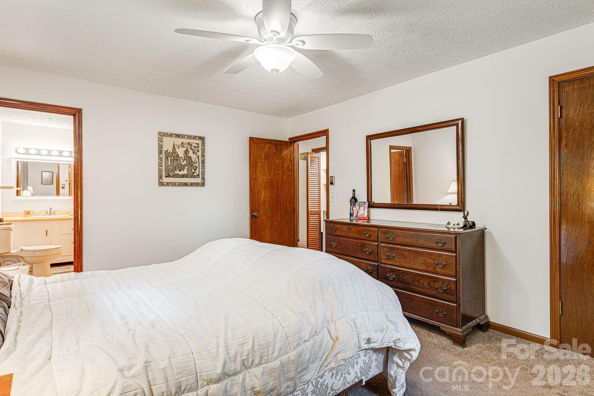61 Spring Cove Drive Brevard, NC 28712 - Photo 19 of 39 a bedroom with a bed and a dresser