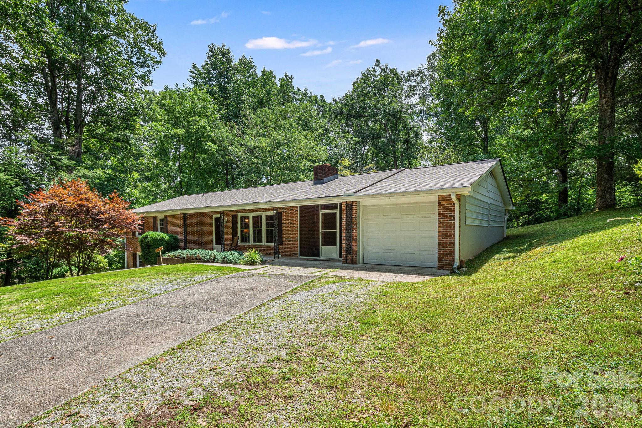61 Spring Cove Drive Brevard, NC 28712 - Photo 2 of 39 a front view of a house with a yard