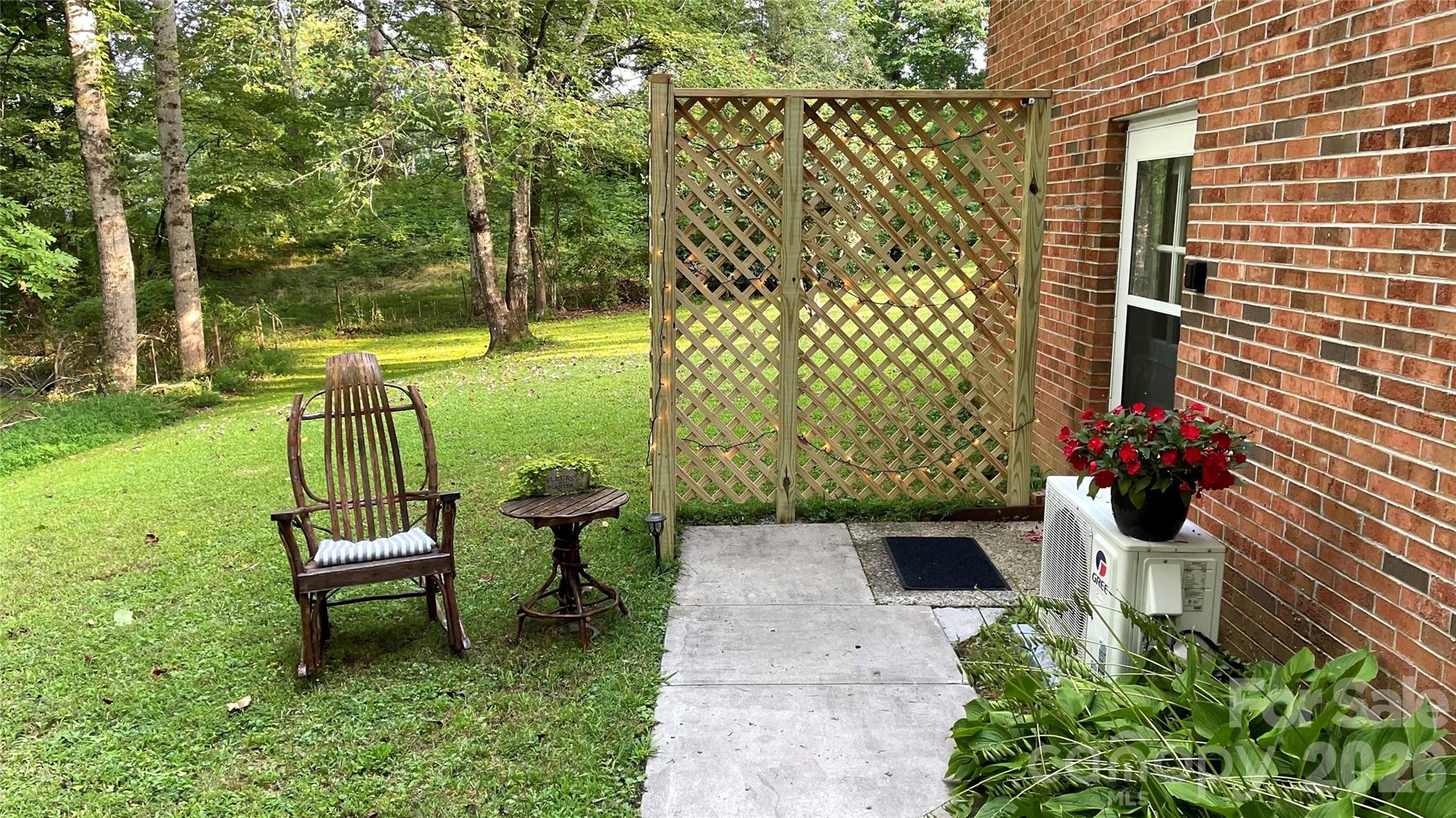 61 Spring Cove Drive Brevard, NC 28712 - Photo 23 of 39 a front view of a garden with a bench