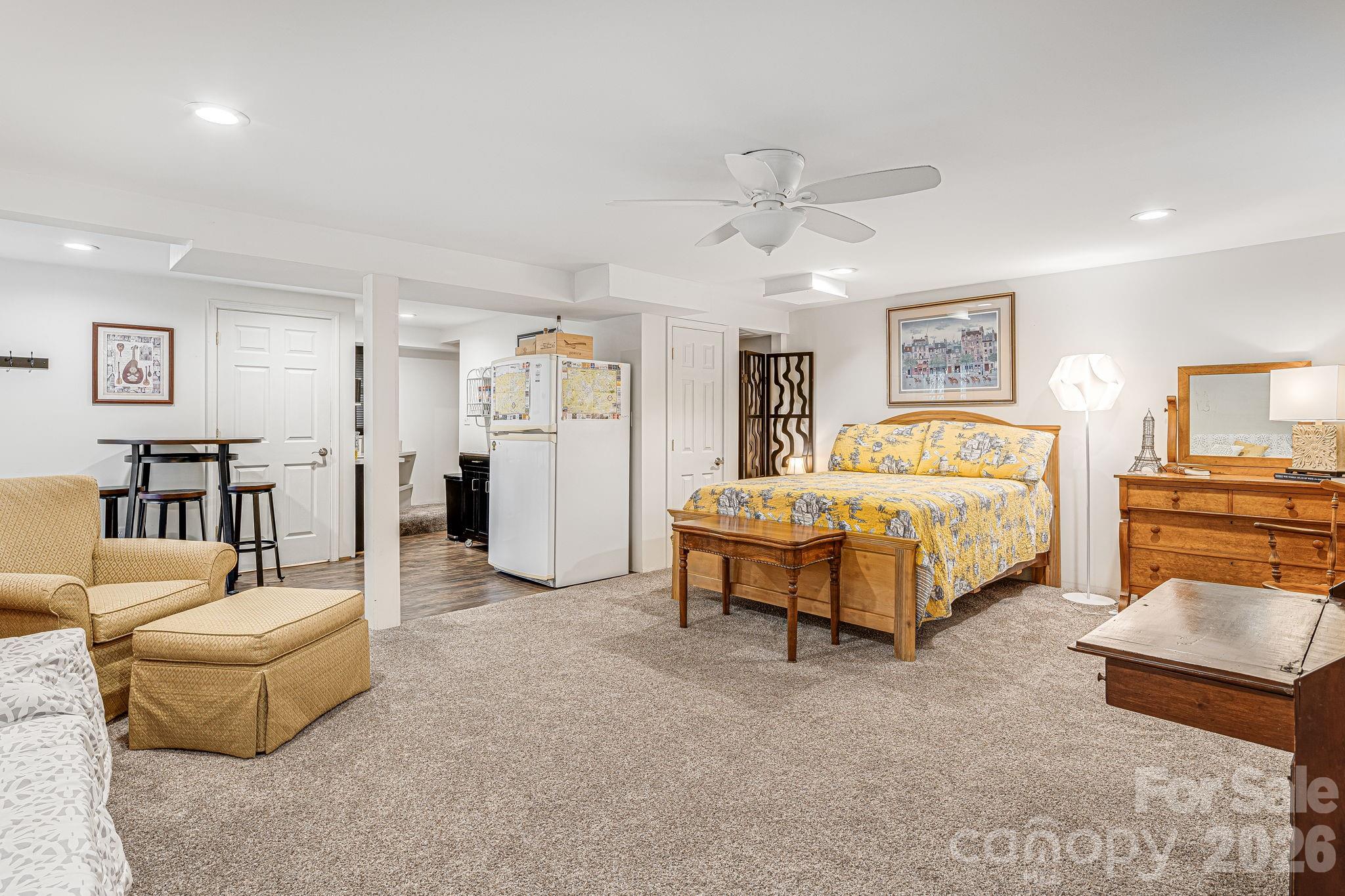 61 Spring Cove Drive Brevard, NC 28712 - Photo 24 of 39 a bedroom with furniture and a chandelier