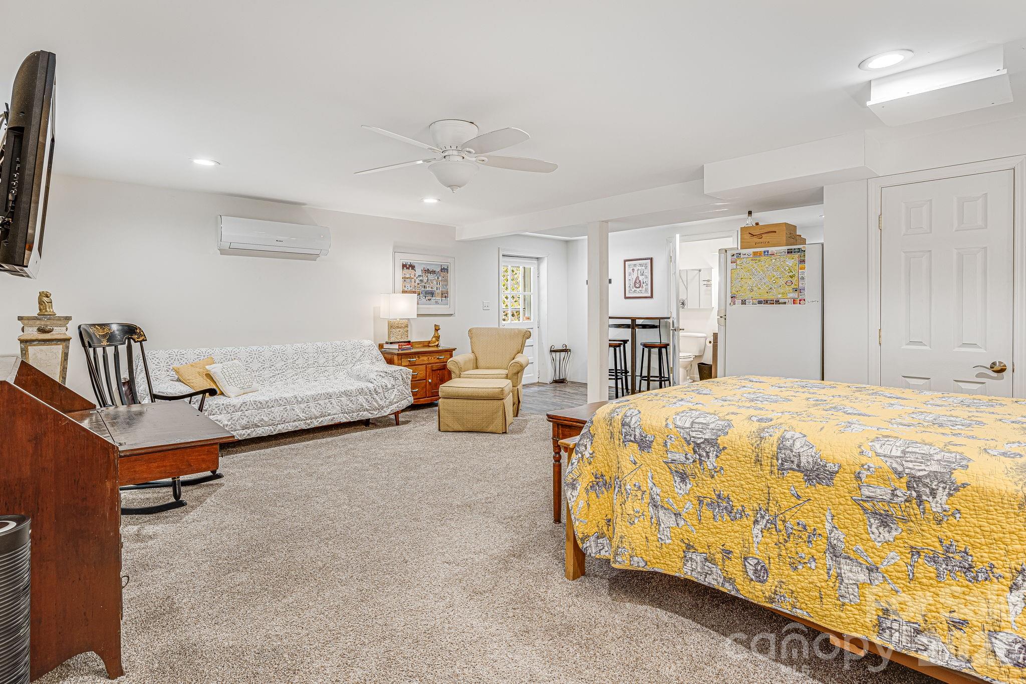 61 Spring Cove Drive Brevard, NC 28712 - Photo 27 of 39 a spacious bedroom with a bed and a chandelier
