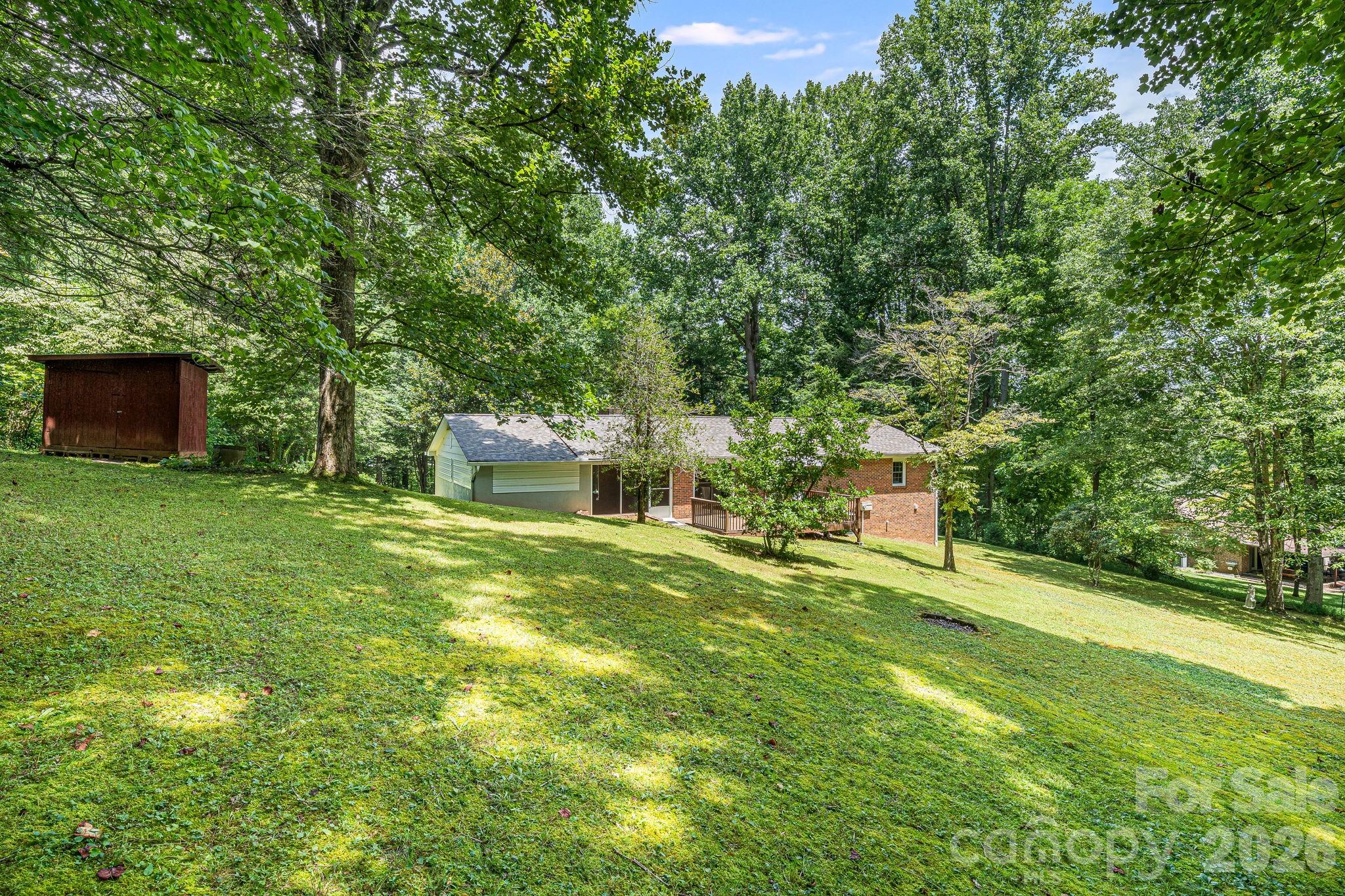 61 Spring Cove Drive Brevard, NC 28712 - Photo 30 of 39 a backyard of a house with table and chairs