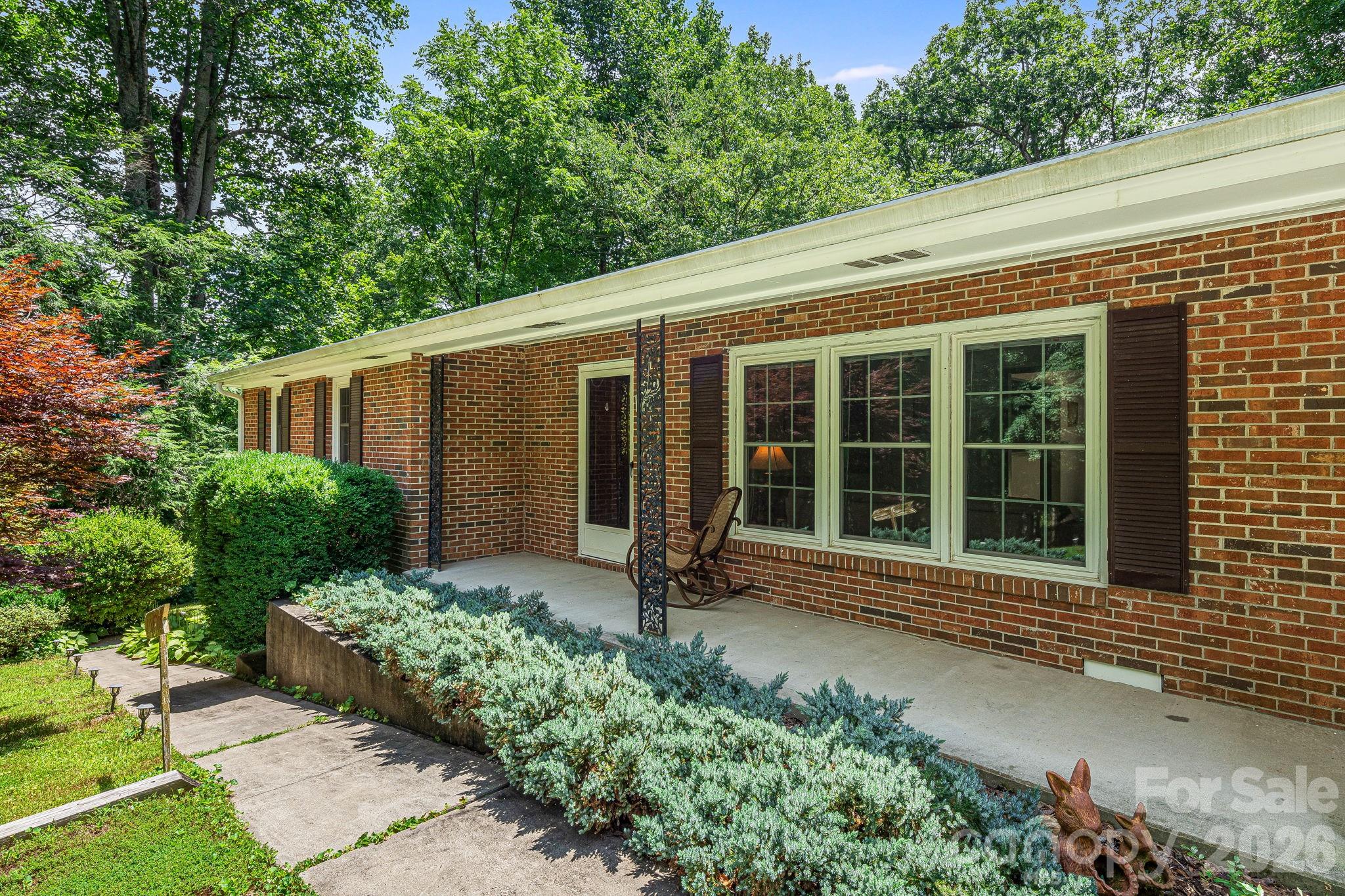 61 Spring Cove Drive Brevard, NC 28712 - Photo 3 of 39 a house with a garden view