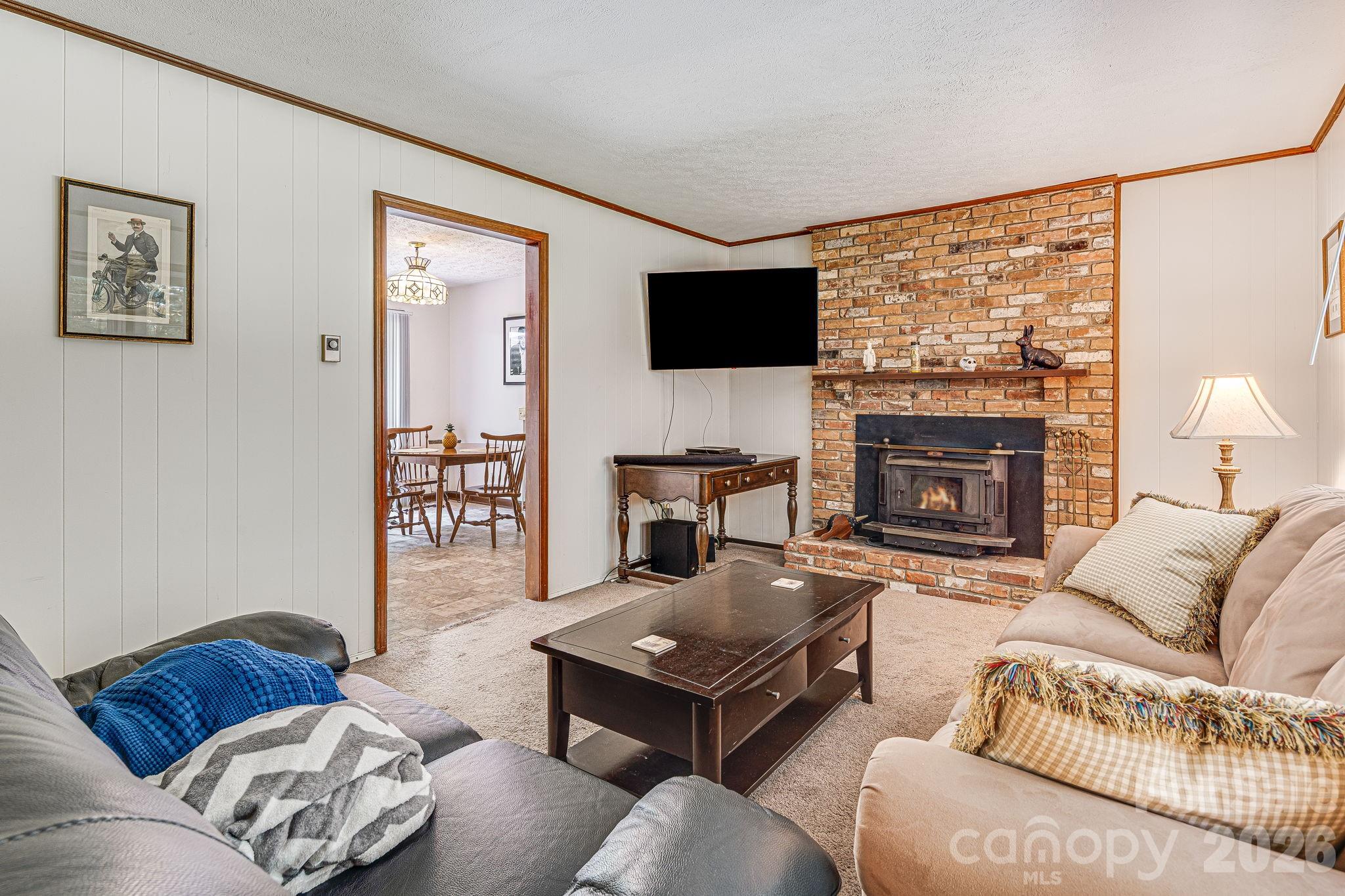 61 Spring Cove Drive Brevard, NC 28712 - Photo 5 of 39 a living room with furniture fireplace and a flat screen tv