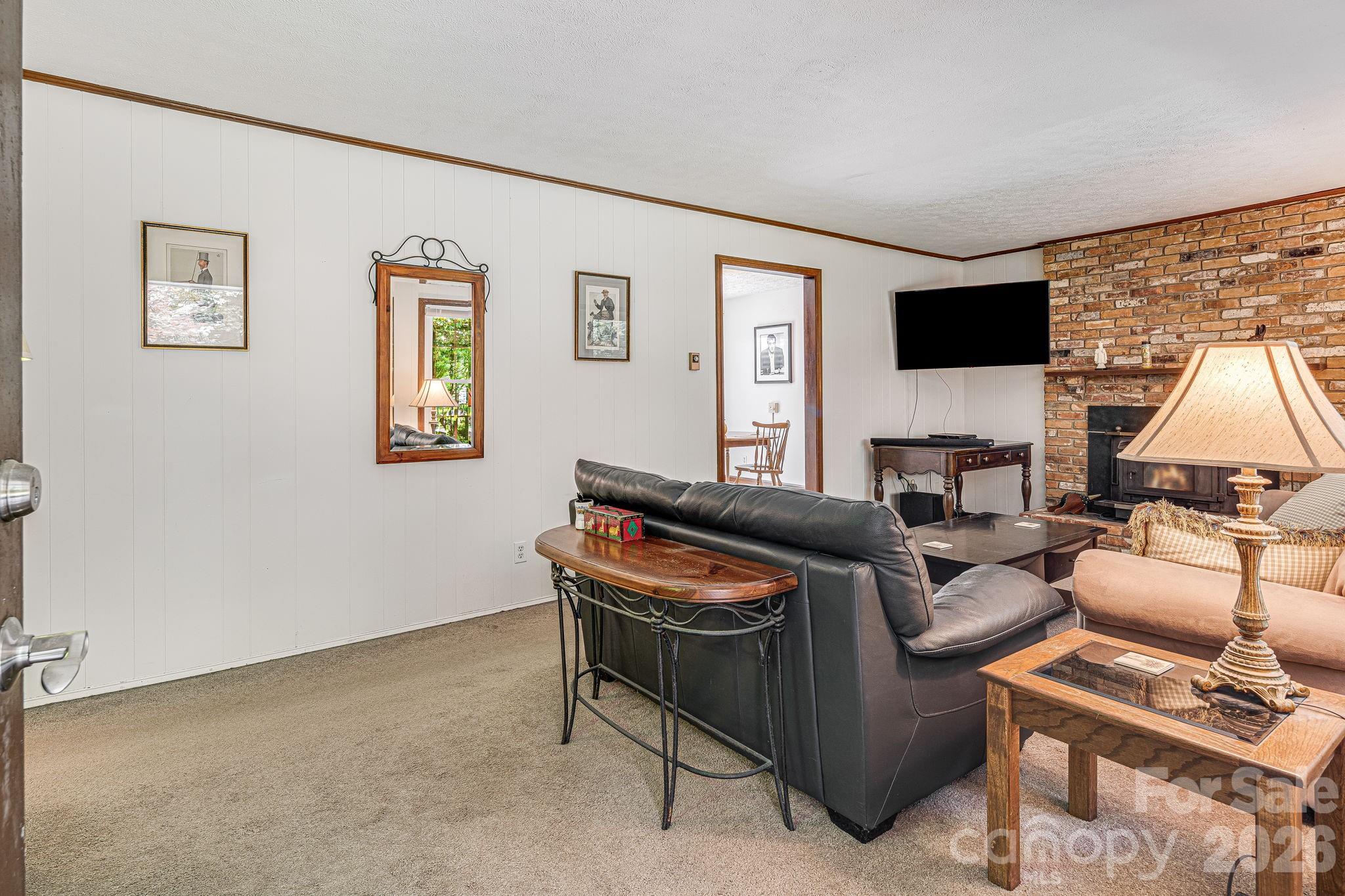 61 Spring Cove Drive Brevard, NC 28712 - Photo 8 of 39 a living room with furniture and a flat screen tv
