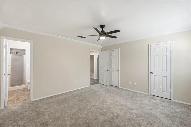 a view of an empty room with a ceiling fan