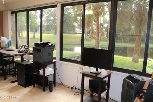 a view of a workspace with furniture and a window