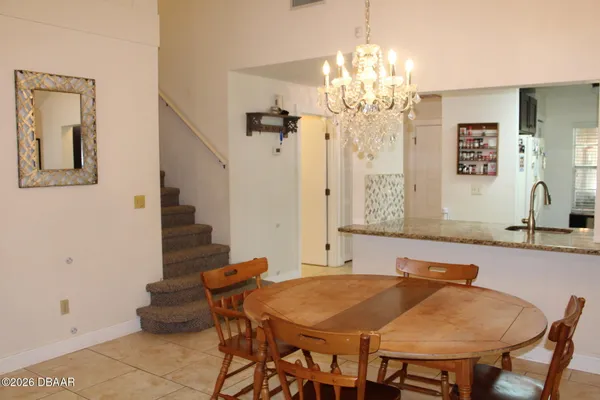 a view of a dining room with furniture and chandelier