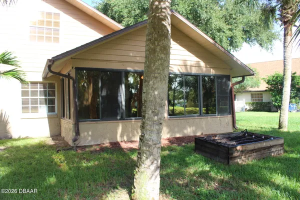 a view of a backyard with a garden and patio
