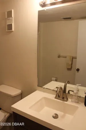 a white toilet sitting next to a shower