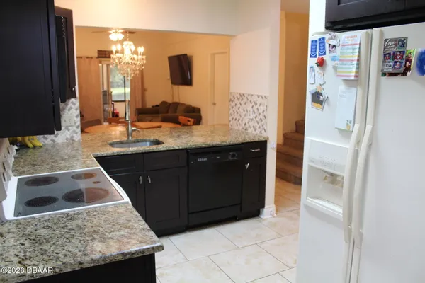 a kitchen with a sink and a refrigerator