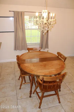 a dining room with furniture and window