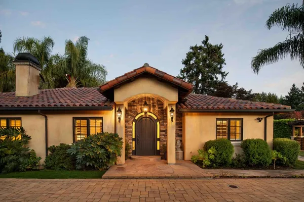 a front view of a house with garden