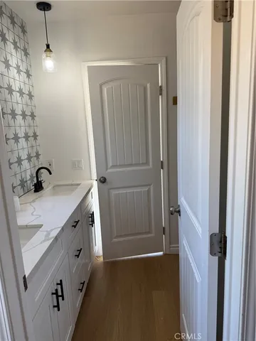 a bathroom with a double vanity sink and mirror