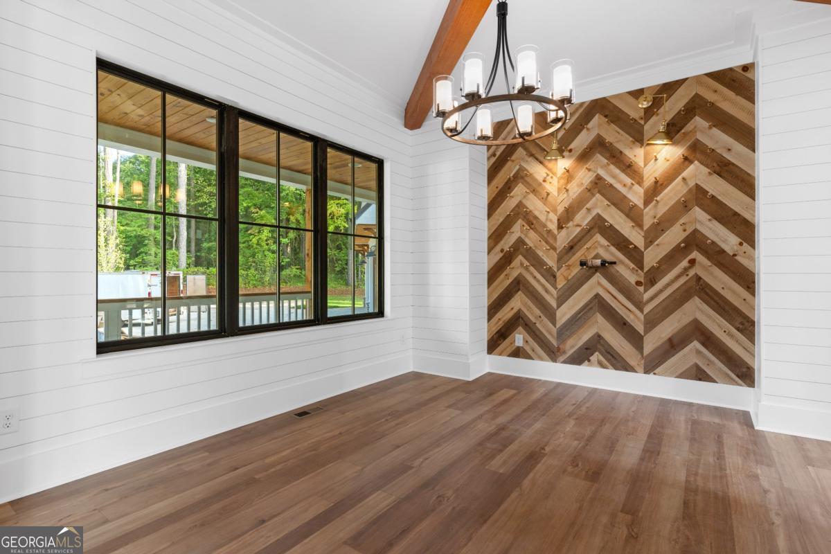 1 Cox Road Roswell, GA 30188 - Photo 13 of 38 a view of an empty room with a window and wooden floor
