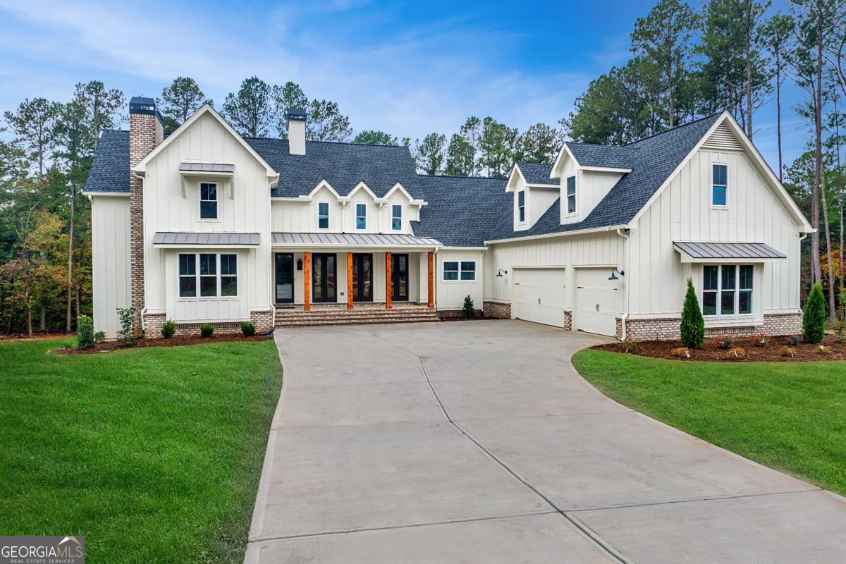 1 Cox Road Roswell, GA 30188 - Photo 3 of 38 a front view of a house with a garden