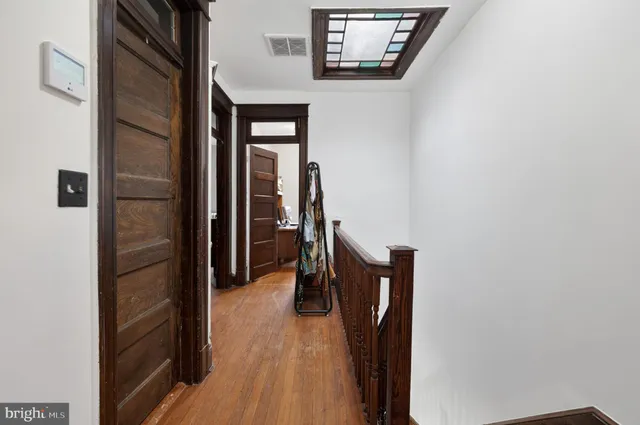 a view of a workspace with furniture and a bookshelf