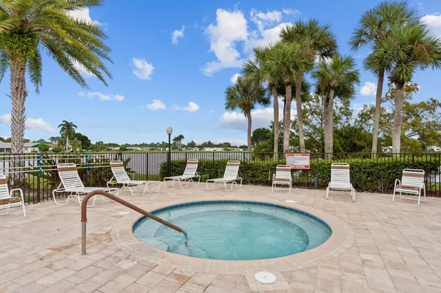 a view of a patio with swimming pool table and chairs