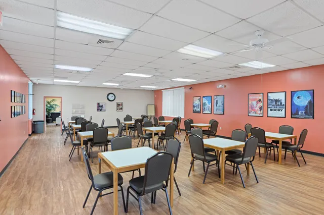 a view of a dining room with furniture and a book shelf