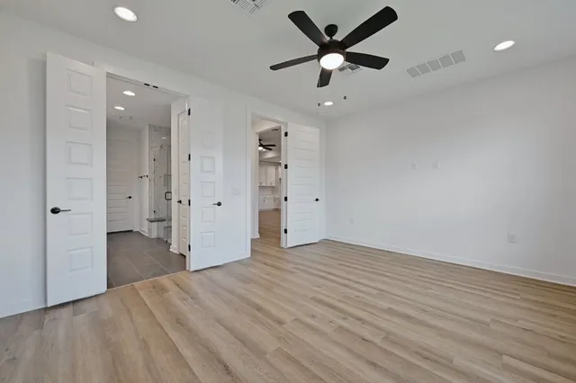 a spacious bathroom with a double vanity sink a large mirror and shower