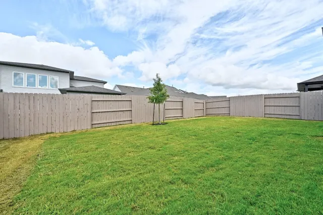 a view of a house with a backyard