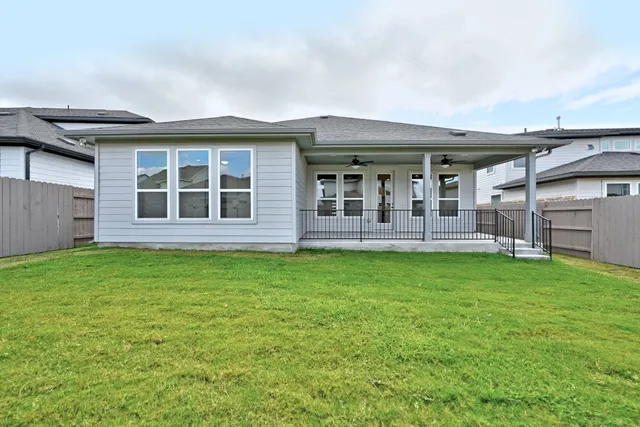 a view of a backyard with a garden and entertaining space