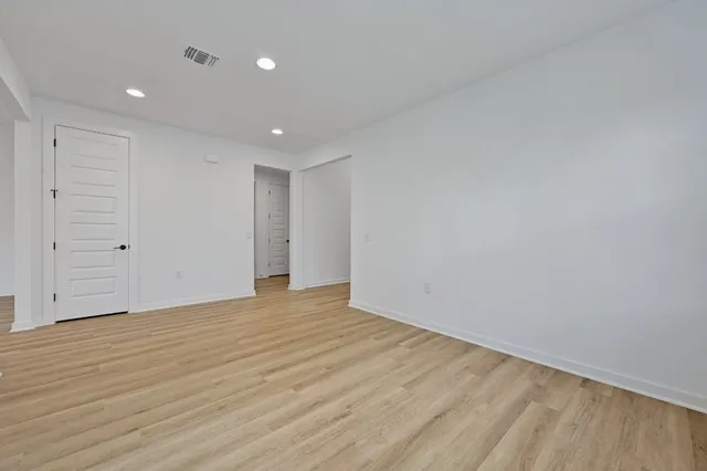 a large kitchen with stainless steel appliances granite countertop a large counter top a sink and a refrigerator