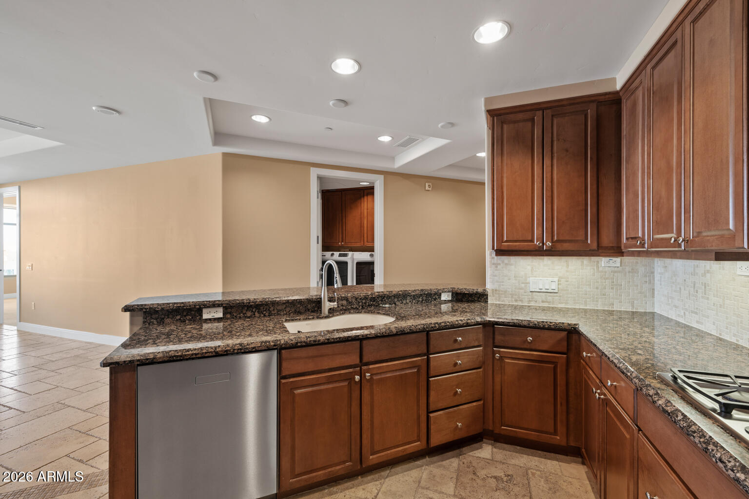 2211 East Camelback Road, Unit 604 Phoenix, AZ 85016 - Photo 5 of 17 a kitchen with granite countertop stainless steel appliances a sink stove and cabinets