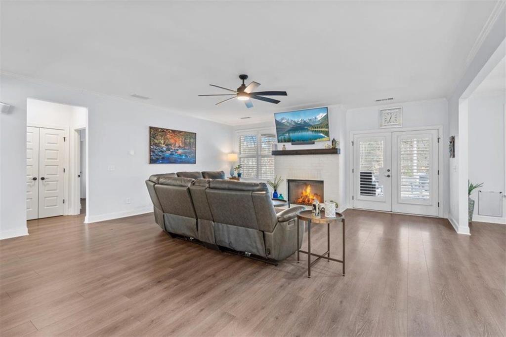 7705 Wandering Oak Way Cumming, GA 30041 - Photo 15 of 57 a living room with furniture and a fireplace