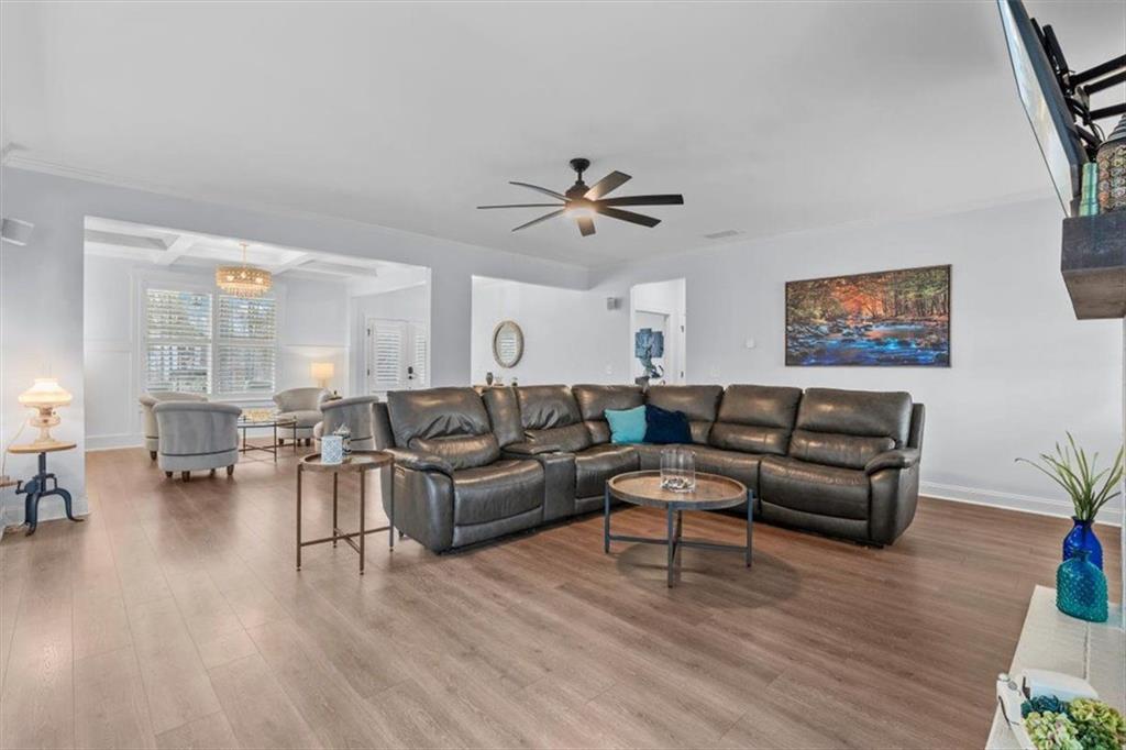 7705 Wandering Oak Way Cumming, GA 30041 - Photo 16 of 57 a living room with furniture and wooden floor