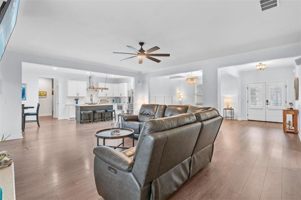 7705 Wandering Oak Way Cumming, GA 30041 - Photo 17 of 57 a living room with furniture and kitchen view