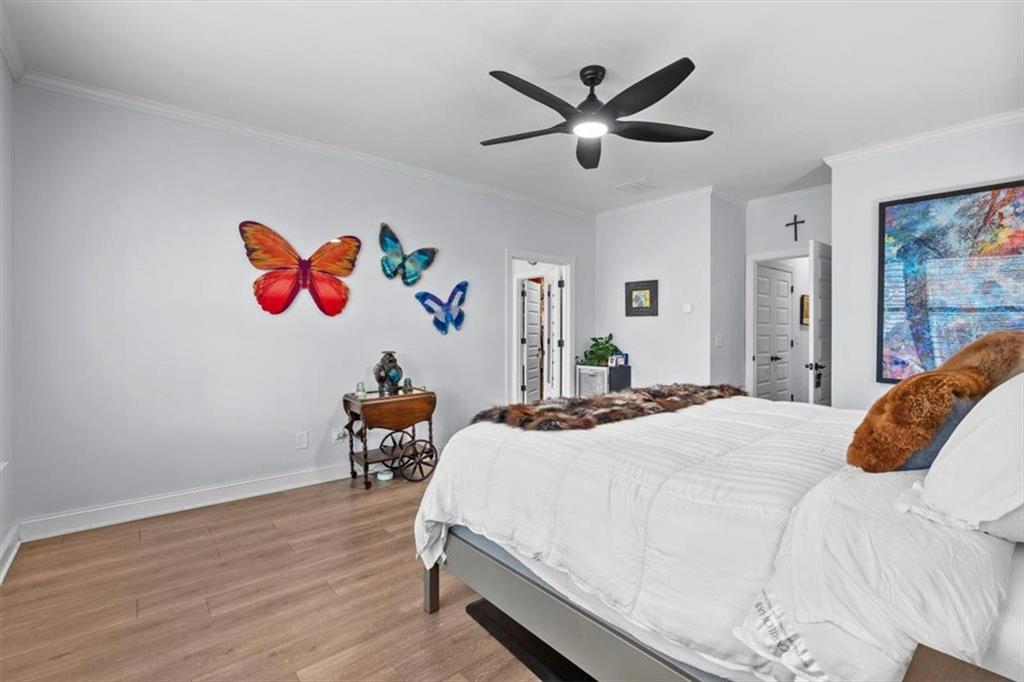 7705 Wandering Oak Way Cumming, GA 30041 - Photo 25 of 57 a bedroom with a bed and a chandelier