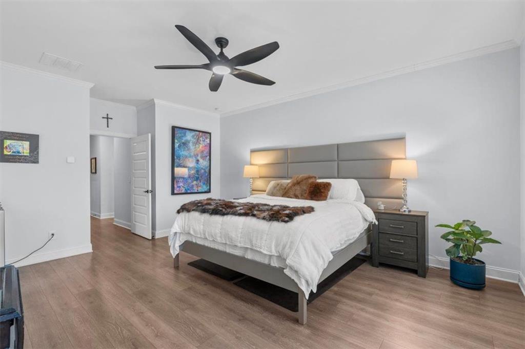 7705 Wandering Oak Way Cumming, GA 30041 - Photo 26 of 57 a bedroom with a bed and painting on the wall