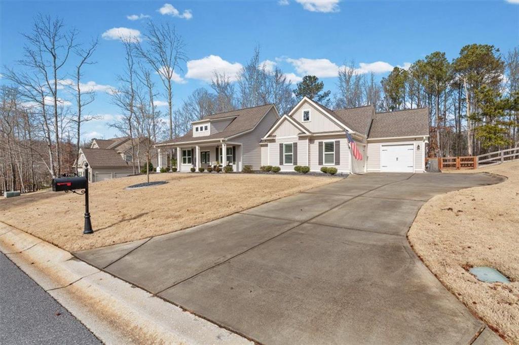 7705 Wandering Oak Way Cumming, GA 30041 - Photo 3 of 57 a front view of a house with a yard
