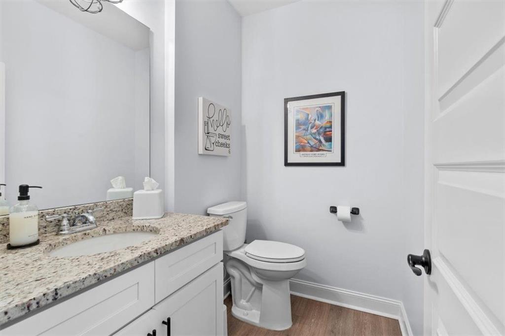 7705 Wandering Oak Way Cumming, GA 30041 - Photo 32 of 57 a bathroom with a granite countertop sink mirror vanity and toilet