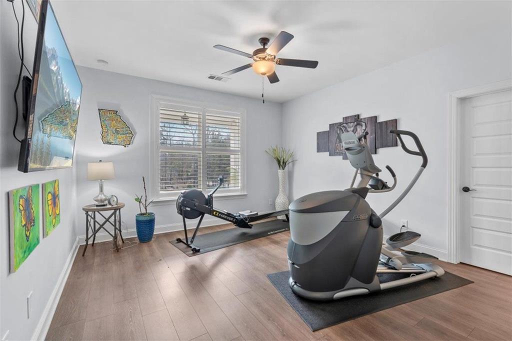 7705 Wandering Oak Way Cumming, GA 30041 - Photo 33 of 57 a room with gym equipment and a large window