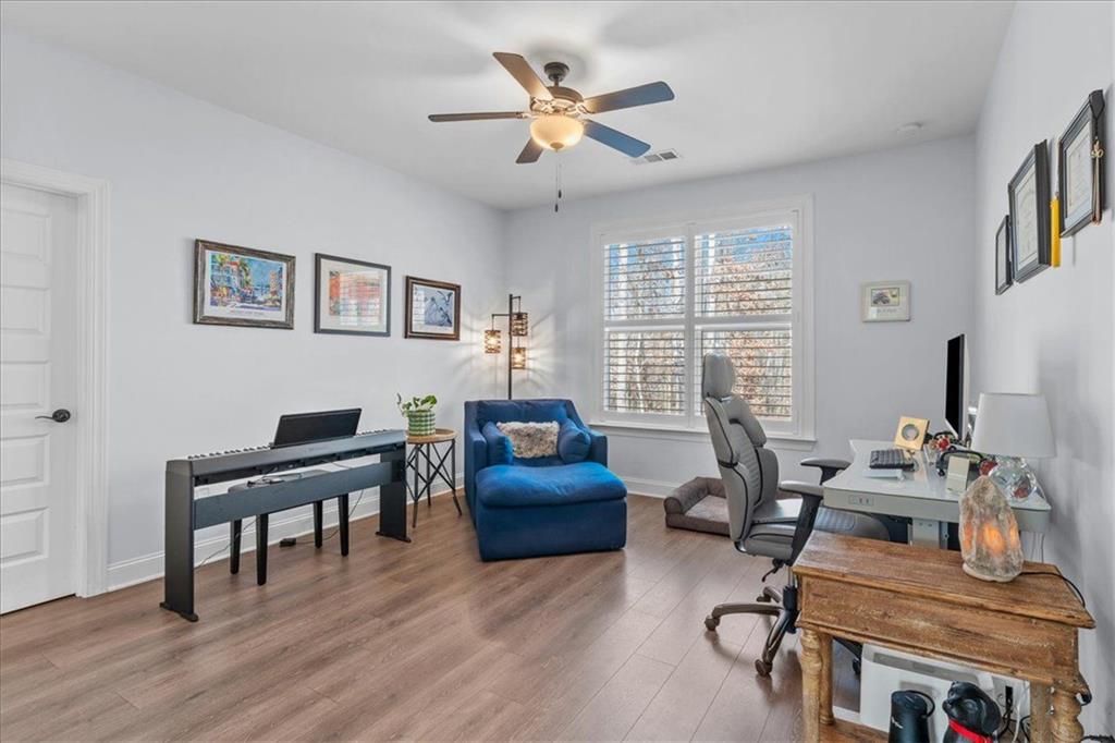 7705 Wandering Oak Way Cumming, GA 30041 - Photo 35 of 57 a living room with furniture