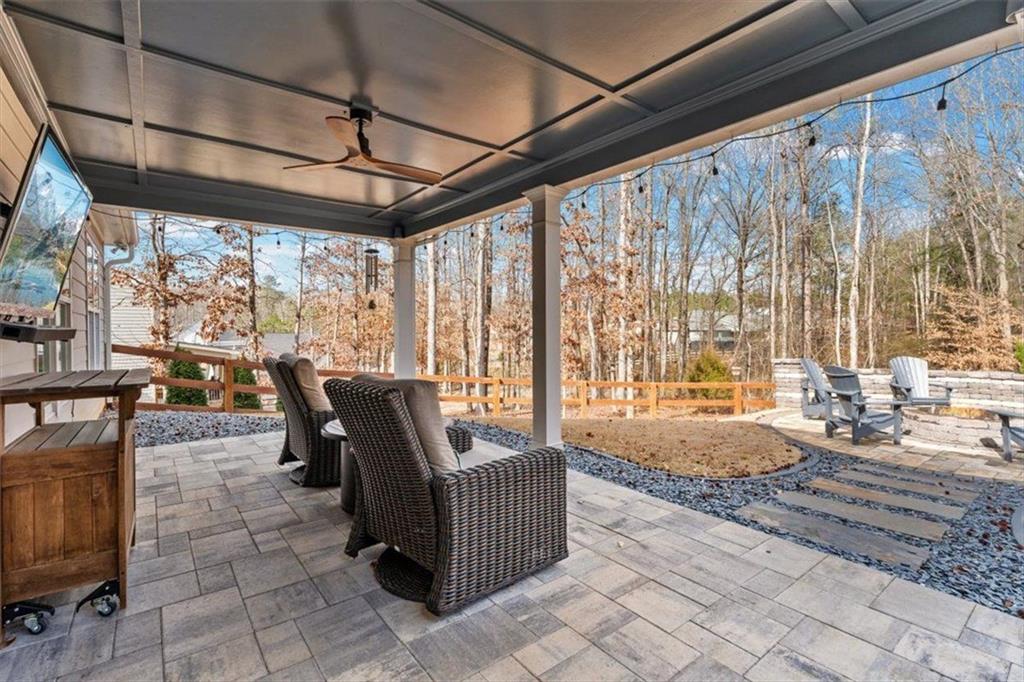 7705 Wandering Oak Way Cumming, GA 30041 - Photo 40 of 57 a living room with furniture and a flat screen tv