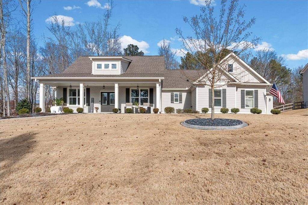 7705 Wandering Oak Way Cumming, GA 30041 - Photo 4 of 57 a front view of a building with a garden and trees
