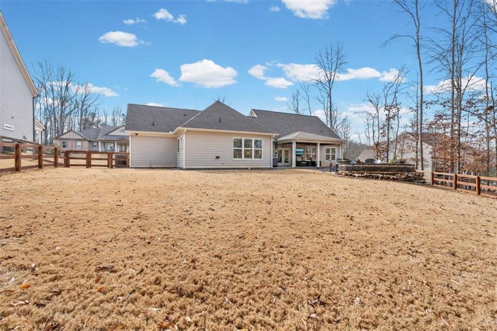 7705 Wandering Oak Way Cumming, GA 30041 - Photo 46 of 57 a view of a house with a yard