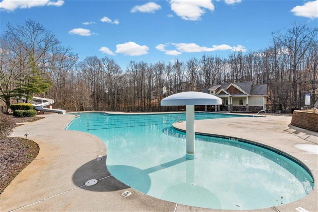 7705 Wandering Oak Way Cumming, GA 30041 - Photo 51 of 57 a swimming pool with outdoor seating and yard