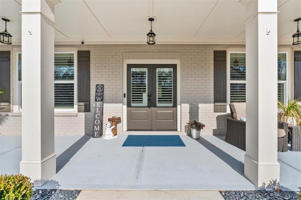 7705 Wandering Oak Way Cumming, GA 30041 - Photo 7 of 57 a view of a entryway door of the house