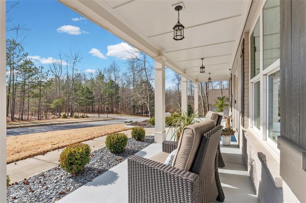 7705 Wandering Oak Way Cumming, GA 30041 - Photo 9 of 57 a view of a living room and a floor to ceiling window or tree