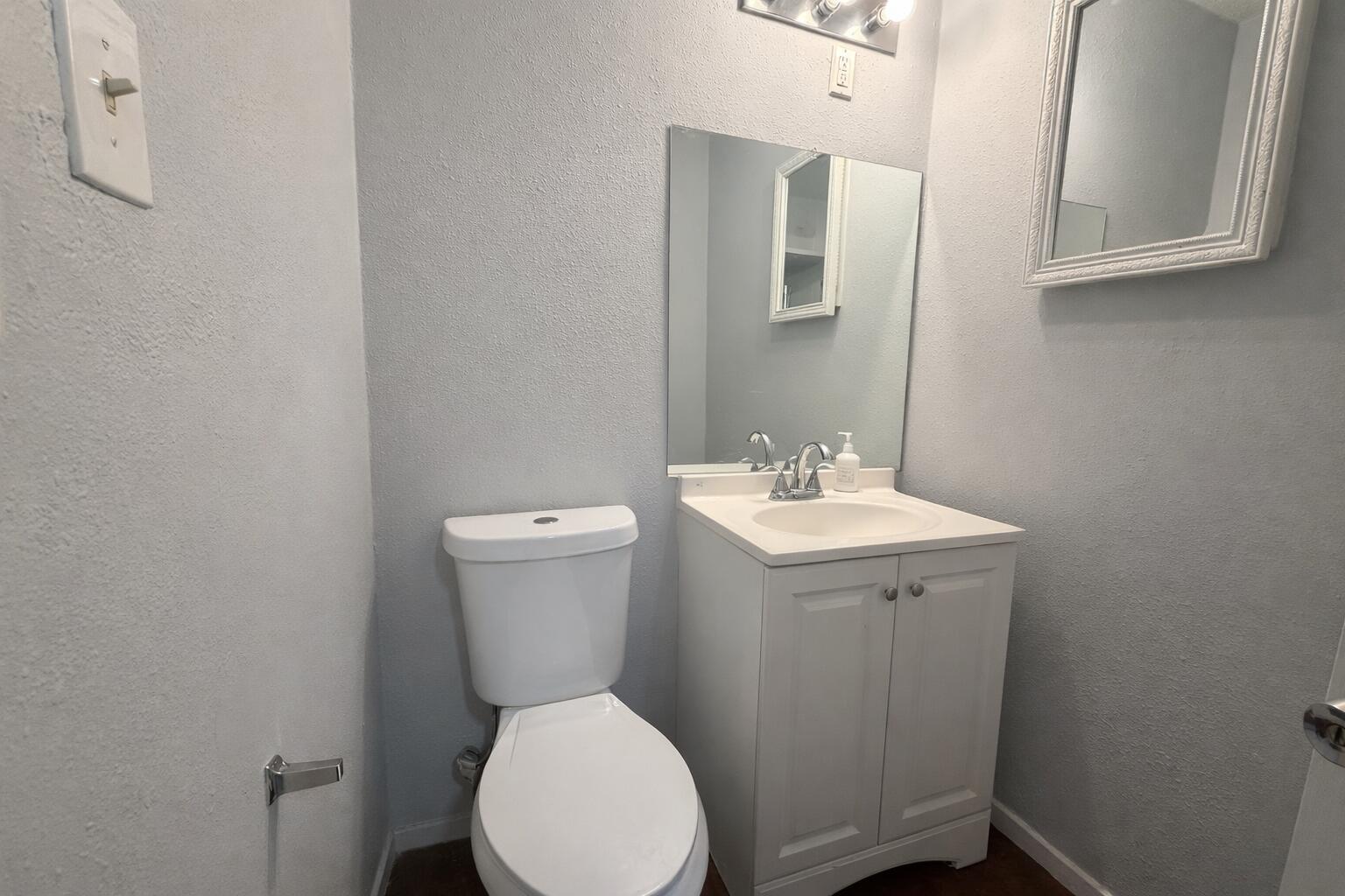 5308 48th Street Lubbock, TX 79414 - Photo 6 of 12 a white toilet sitting next to a bathroom sink