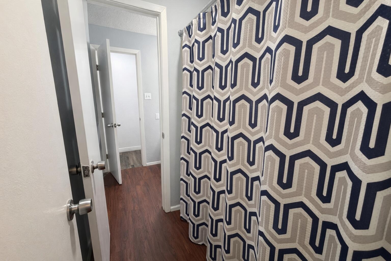 5308 48th Street Lubbock, TX 79414 - Photo 7 of 12 a view of an entryway with wooden floor